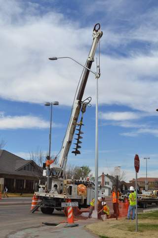 Work Crews Installing New Light Near City Complex